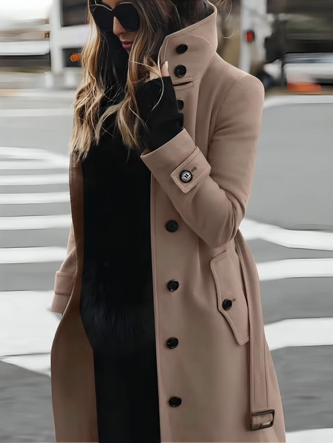 Stylish long women's coat with a high collar and elegant bow belt